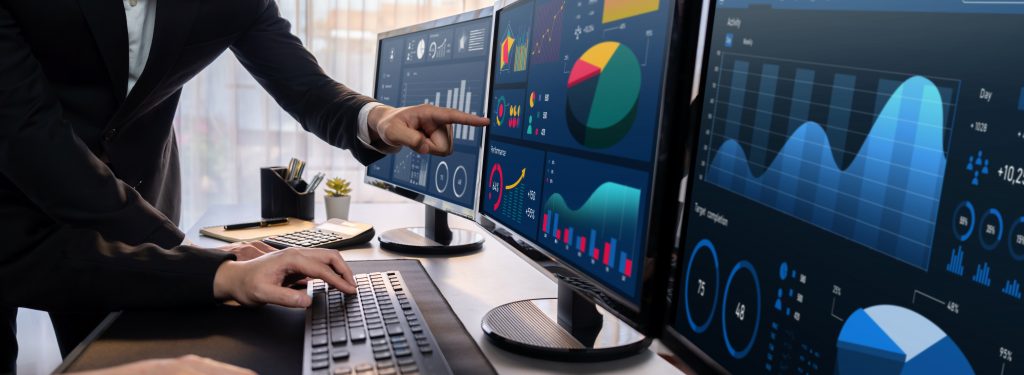 Analyst working on BI dashboard on computer monitor. Trailblazing